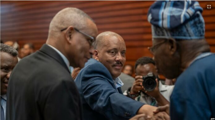 President of Interim Regional Administration of Tigray Getachew Reda, center, and Chairman of Tigray People's Liberation Front Debretsion Gebremichael, left, shake hands with Former President of Nigeria Olusegun Obasanjo at the AU Headquarters in Addis Ababa on Feb. 16, 2025.